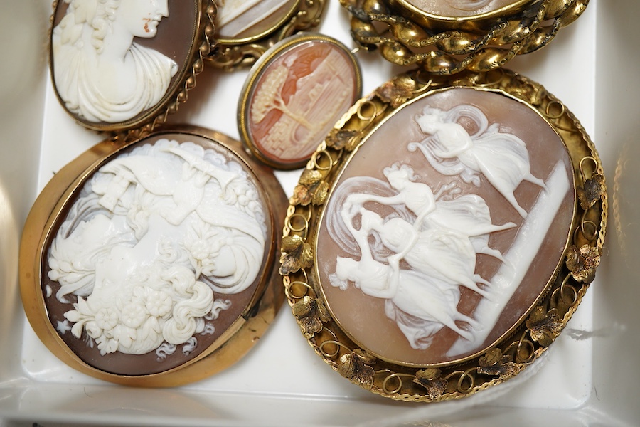 Six assorted Victorian and later yellow or white metal mounted oval cameo shells, one frame stamped 9ct, largest 64mm.